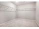 Spacious walk-in closet with wire shelving and plush carpet flooring. Ready for organization at 1007 Sora Way, Durham, NC 27703