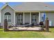 Covered patio with comfortable seating area and an outdoor grill for entertaining at 101 Hazel Ln Ln, Broadway, NC 27505