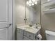 Bathroom with a white cabinet and marble countertop with sink and toiletries at 101 Hazel Ln Ln, Broadway, NC 27505