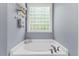 Bathroom with a corner tub and window at 101 Hazel Ln Ln, Broadway, NC 27505