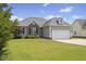 Charming single Gathering home featuring a two-car garage and landscaped front yard at 101 Hazel Ln Ln, Broadway, NC 27505
