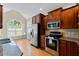 Bright kitchen with stainless steel appliances, granite countertops, hardwood floors, and cherry cabinets at 101 Hazel Ln Ln, Broadway, NC 27505
