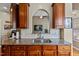 Close-up of a kitchen sink area featuring granite countertops, hardwood floors, and cherry cabinets at 101 Hazel Ln Ln, Broadway, NC 27505