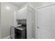Laundry room with front-load washer, dryer, and overhead cabinets at 101 Hazel Ln Ln, Broadway, NC 27505