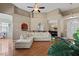 Open-concept living room featuring hardwood floors, a large sectional sofa, and a ceiling fan at 101 Hazel Ln Ln, Broadway, NC 27505