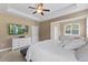 Bright main bedroom with tray ceiling, ceiling fan, and wall-mounted TV at 101 Hazel Ln Ln, Broadway, NC 27505