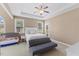 Bright main bedroom with a ceiling fan, tray ceiling, and seating area at 101 Hazel Ln Ln, Broadway, NC 27505