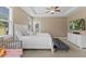 Bright main bedroom with ceiling fan, TV, and windows that provide plenty of natural light at 101 Hazel Ln Ln, Broadway, NC 27505