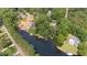 Aerial view features homes with lake access, a boat launch and a serene tree-lined neighborhood at 1033 Sagamore Dr, Louisburg, NC 27549