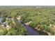 Expansive aerial view showing neighborhood with tree coverage, lake access and waterfront properties at 1033 Sagamore Dr, Louisburg, NC 27549