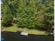 Aerial view showcases lakefront home with a private pier, lush lawn, and surrounding mature trees at 1033 Sagamore Dr, Louisburg, NC 27549