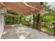 Wooden back porch with awning, landscaping and lakeside views at 1033 Sagamore Dr, Louisburg, NC 27549