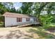 Quaint single-story home with a ramp, surrounded by lush greenery, nestled near a serene lake at 1033 Sagamore Dr, Louisburg, NC 27549