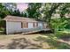 Charming single story home featuring vinyl siding, red shutters, lakeside access and a wheelchair ramp at 1033 Sagamore Dr, Louisburg, NC 27549