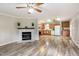 Bright living room featuring wood flooring, a fireplace, and a combined kitchen dining area at 1033 Sagamore Dr, Louisburg, NC 27549
