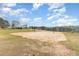 Outdoor sand volleyball court with lake views next to blue building at 1033 Sagamore Dr, Louisburg, NC 27549