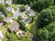 A high angle shot reveals a home with a sprawling yard, accented by mature trees at 107 Woolard Way, Apex, NC 27502