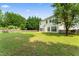 Lush backyard featuring a generous grassy area, enclosed by a classic wooden fence at 107 Woolard Way, Apex, NC 27502