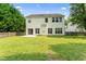 A spacious backyard offers a private outdoor area, framed by trees and a wood fence at 107 Woolard Way, Apex, NC 27502