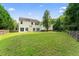 Expansive backyard featuring a well-maintained lawn and mature trees, perfect for outdoor activities and relaxation at 107 Woolard Way, Apex, NC 27502