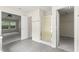 Bathroom features a glass enclosed shower, access to a closet and view to the main bedroom at 107 Woolard Way, Apex, NC 27502