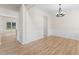 Dining room with hardwood floors, decorative wainscoting, a modern chandelier, and natural light at 107 Woolard Way, Apex, NC 27502