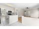 Updated kitchen area with white cabinets, quartz counters, stainless-steel appliances, and tile flooring at 107 Woolard Way, Apex, NC 27502