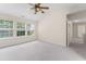 Bright main bedroom featuring carpet and windows that offer abundant natural light and a relaxing atmosphere at 107 Woolard Way, Apex, NC 27502