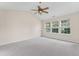 Large main bedroom with carpet, a ceiling fan, and multiple windows, offering plenty of space and light at 107 Woolard Way, Apex, NC 27502