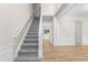 Carpeted staircase with white trim leading to the upper level, complemented by wainscoting details at 107 Woolard Way, Apex, NC 27502