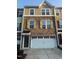 Charming multi-story townhome with brick and shingle siding, complemented by a convenient two-car garage at 1141 Boxcar Way, Apex, NC 27502