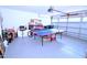 Garage with a ping pong table, offering a flexible space for recreation and storage at 1141 Boxcar Way, Apex, NC 27502