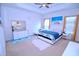 Serene bedroom with a king-sized bed, tray ceiling, ample natural light, and a cozy sitting area at 1141 Boxcar Way, Apex, NC 27502