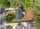 Aerial view of a home with a wooden deck, grassy backyard, and mature trees at 1143 Sturdivant Dr, Cary, NC 27511