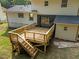 Two story home back deck with wooden railings and stairs leading to a grassy backyard at 1143 Sturdivant Dr, Cary, NC 27511
