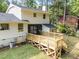 Two-story home featuring a wooden deck and grassy backyard with mature trees and white siding at 1143 Sturdivant Dr, Cary, NC 27511