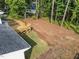 Aerial view of a home with a wooden deck and grassy backyard bordered by mature trees at 1143 Sturdivant Dr, Cary, NC 27511