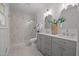 Stylish bathroom with a double vanity, decorative mirrors, and a glass-enclosed tiled shower at 1143 Sturdivant Dr, Cary, NC 27511