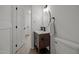 Cozy bathroom with a wood vanity, oval mirror, and tiled walls at 1143 Sturdivant Dr, Cary, NC 27511