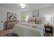 Bright, well-appointed bedroom featuring neutral tones, a large bed, and an artistic touch at 1143 Sturdivant Dr, Cary, NC 27511