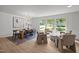 Open-concept dining area with an elegant chandelier and sun-filled seating by the large window at 1143 Sturdivant Dr, Cary, NC 27511