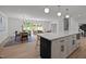 Bright living space featuring a modern kitchen island, dining table, and comfortable seating area at 1143 Sturdivant Dr, Cary, NC 27511