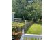 Back yard with a fenced in area for animals and a beautiful lush lawn with mature trees at 11609 Us 401, Fuquay Varina, NC 27526
