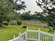 This backyard view includes a fenced pasture, outbuildings and green space at 11609 Us 401, Fuquay Varina, NC 27526
