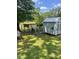 This exterior image displays a well-maintained chicken coop with both an enclosed shelter and spacious outdoor area at 11609 Us 401, Fuquay Varina, NC 27526