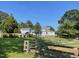 View of a two-story home featuring a metal gate and fenced-in yard at 11609 Us 401, Fuquay Varina, NC 27526