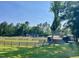 Picturesque horse property featuring fenced pastures, a barn, and a serene, tree-lined backdrop on a sunny day at 11609 Us 401, Fuquay Varina, NC 27526