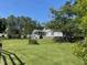 The well-manicured lawn surrounds this single Gathering home with a white fence at 11609 Us 401, Fuquay Varina, NC 27526