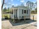 Charming small home with a covered porch, set on a gravel lot with mature trees. Includes a golf cart at 11609 Us 401, Fuquay Varina, NC 27526