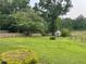 Manicured lawn with a small shed in a fenced backyard perfect for pets at 11609 Us 401, Fuquay Varina, NC 27526